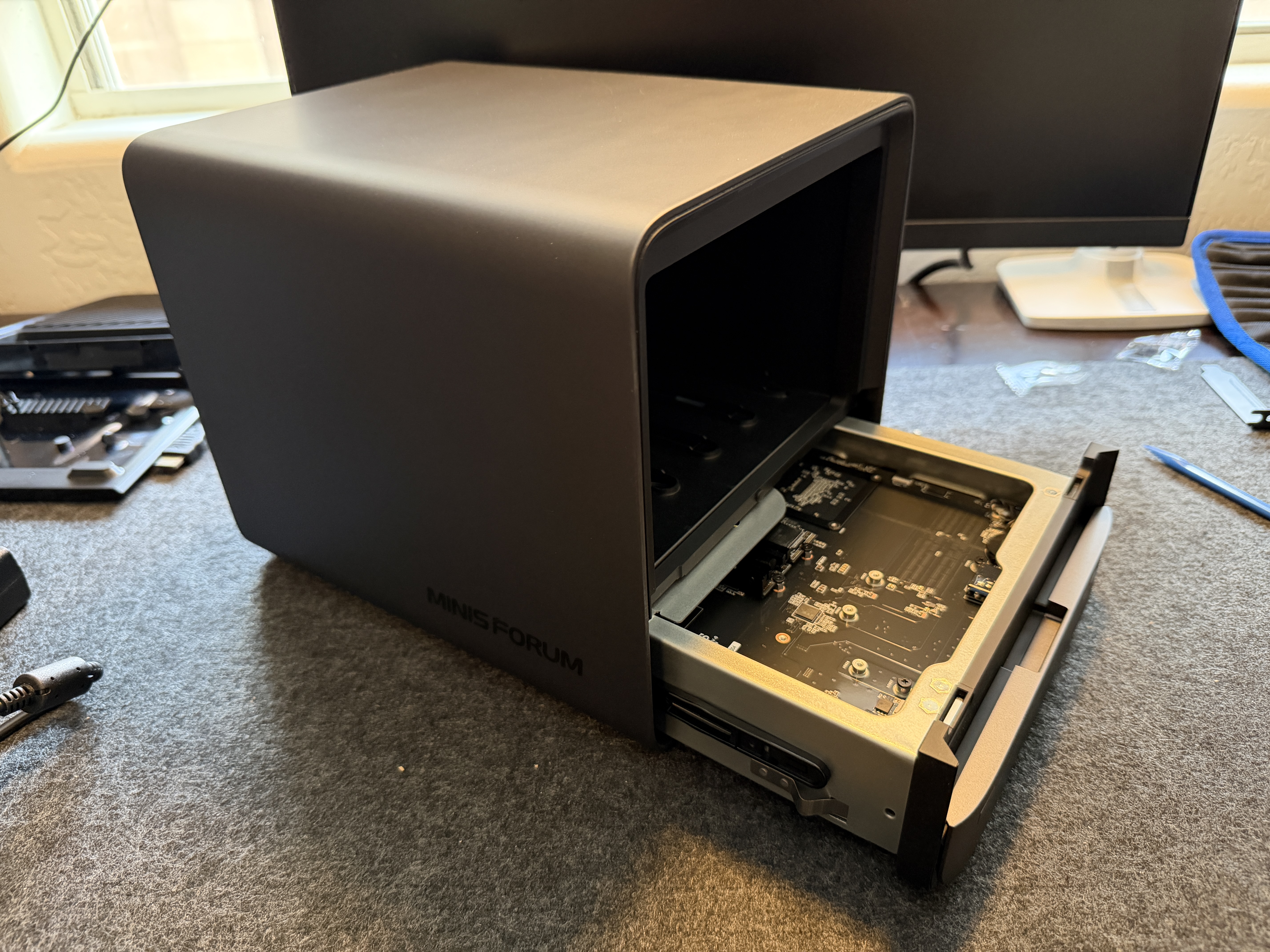 Minisforum N5 Air with motherboard tray slid out from front showing the slide-out design feature