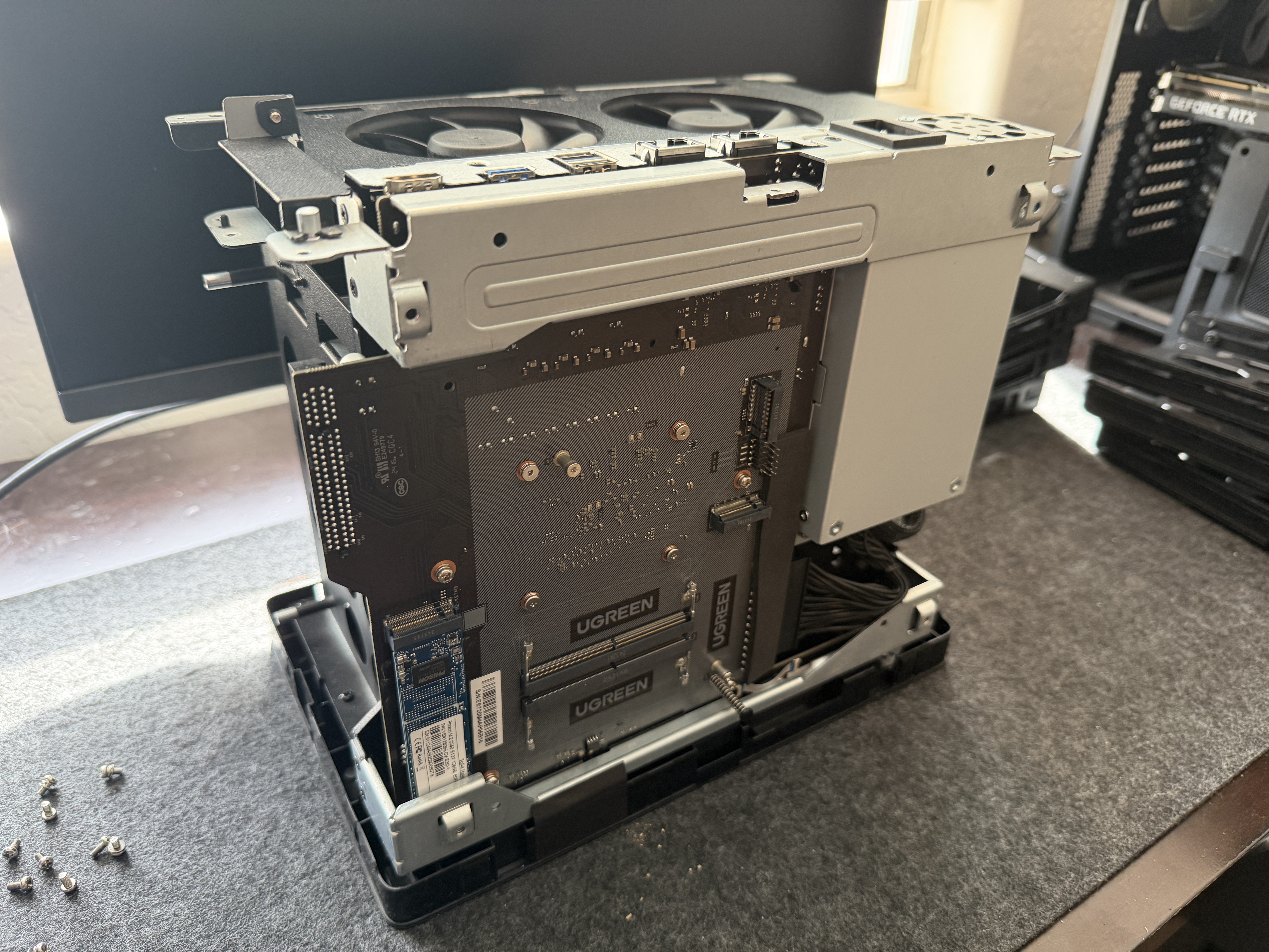 UGREEN DXP6800 Pro fully disassembled showing motherboard, integrated PSU, fans, and internal frame